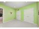 Bright, green room with wall art and ample closet space, suitable for children or guests at 5404 Cayman Dr, Carmel, IN 46033