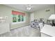 Bright bedroom with a view, featuring a ceiling fan, natural light, and light green walls at 5404 Cayman Dr, Carmel, IN 46033