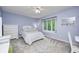 Comfortable bedroom with a large window, featuring a full bed, dresser, and desk at 5404 Cayman Dr, Carmel, IN 46033