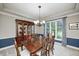 Traditional dining room with wood table and chairs, hutch, and chandelier at 5404 Cayman Dr, Carmel, IN 46033