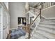 Spacious foyer featuring hardwood floors, carpeted stairs, and a chandelier, creating a welcoming entrance at 5404 Cayman Dr, Carmel, IN 46033