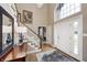 Bright foyer with hardwood floors, stairs, an elegant chandelier and a window bringing in natural light at 5404 Cayman Dr, Carmel, IN 46033