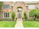 Elegant brick facade with arched entryway and landscaped walkway leading to front door at 5404 Cayman Dr, Carmel, IN 46033