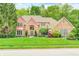 Charming brick home featuring a manicured lawn and mature trees, perfect for curb appeal at 5404 Cayman Dr, Carmel, IN 46033