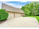 Spacious three-car garage with ample parking and a neatly landscaped yard at 5404 Cayman Dr, Carmel, IN 46033