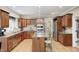 Well-lit kitchen with wood cabinets, granite countertops, stainless steel appliances, and central island at 5404 Cayman Dr, Carmel, IN 46033