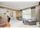 Inviting living room with large windows, cozy armchairs and carpet, creating a relaxing and bright atmosphere at 5404 Cayman Dr, Carmel, IN 46033