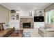 Living room boasts a brick fireplace, built-in shelves, and comfortable seating, perfect for Gathering gatherings at 5404 Cayman Dr, Carmel, IN 46033