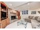 Cozy living room features a brick fireplace, custom built-ins, and comfortable seating with a glass coffee table at 5404 Cayman Dr, Carmel, IN 46033