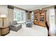 Comfortable living room features cozy armchairs, natural light, and a wooden cabinet adding warmth and character at 5404 Cayman Dr, Carmel, IN 46033