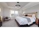 Bright bedroom featuring tray ceilings, a neutral palette and comfortable seating area at 569 Dalton Way, Avon, IN 46123