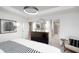 Modern bedroom with black dresser, round mirror, and neutral decor at 569 Dalton Way, Avon, IN 46123