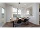 The dining room showcases a rustic wood table with modern chairs, a pendant light, and backyard views at 569 Dalton Way, Avon, IN 46123