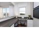 Well-lit home office with a built-in desk, stylish chairs, and bright windows providing natural light at 569 Dalton Way, Avon, IN 46123