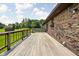 A wooden deck with a railing overlooks a large yard with green grass and trees at 5905 N County Rd 600 E, Brownsburg, IN 46112