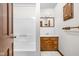Bathroom features a white shower, a wood vanity, and a framed mirror with vanity lighting at 5905 N County Rd 600 E, Brownsburg, IN 46112