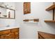 Bathroom with wood vanity and drawers, a framed mirror with vanity lighting and wood shelves at 5905 N County Rd 600 E, Brownsburg, IN 46112