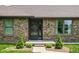 Inviting front entrance with a stylish door, brick accents, and manicured shrubs at 5905 N County Rd 600 E, Brownsburg, IN 46112