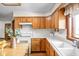 Kitchen features wooden cabinets, white appliances, white countertop and a white tile backsplash at 5905 N County Rd 600 E, Brownsburg, IN 46112