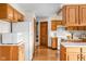 Spacious kitchen with wood cabinets, white appliances, and hardwood floors at 5905 N County Rd 600 E, Brownsburg, IN 46112