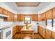 Bright kitchen with wooden cabinets, white countertops, and a center island table at 5905 N County Rd 600 E, Brownsburg, IN 46112