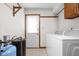 The laundry room features a utility sink, a washer and dryer and an exterior door at 5905 N County Rd 600 E, Brownsburg, IN 46112