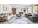Spacious living room with ample seating, a cozy fireplace, and natural light at 5905 N County Rd 600 E, Brownsburg, IN 46112