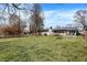 Spacious backyard with mature trees, a fire pit, storage shed and screened in porch at 634 Park Dr, Greenwood, IN 46143