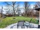 Relaxing backyard featuring a deck, comfortable seating, a fire pit, and mature trees at 634 Park Dr, Greenwood, IN 46143