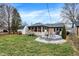 Expansive backyard with a deck, screened-in porch, storage shed, and lush green grass at 634 Park Dr, Greenwood, IN 46143