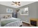 Neutral toned bedroom with a queen bed, two windows, and ceiling fan at 634 Park Dr, Greenwood, IN 46143