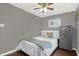 Neutral toned bedroom with a queen bed, two windows, ceiling fan, and large safe at 634 Park Dr, Greenwood, IN 46143