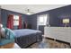 Comfortable bedroom with a ceiling fan, multiple windows, and a large dresser at 634 Park Dr, Greenwood, IN 46143