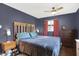 A large bedroom with a ceiling fan, neutral paint color and matching furniture at 634 Park Dr, Greenwood, IN 46143