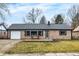 Charming single-story home with a brick facade, attached garage, and cozy front porch area at 634 Park Dr, Greenwood, IN 46143
