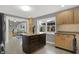 A kitchen featuring a stone tile floor, wood cabinets, an island with granite countertop and stainless steel appliances at 634 Park Dr, Greenwood, IN 46143