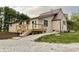 Home's backyard features a spacious lawn and a wooden deck, perfect for outdoor gatherings at 6593 N 800 W, Elwood, IN 46036