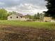 Home's backyard features a spacious lawn and a wooden deck, perfect for outdoor gatherings at 6593 N 800 W, Elwood, IN 46036