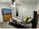 Bedroom featuring a ceiling fan, dresser, closet and neutral walls at 6593 N 800 W, Elwood, IN 46036