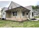 Charming two-story home featuring a metal roof and inviting porch with flower baskets at 6593 N 800 W, Elwood, IN 46036