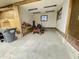 Well-lit garage featuring ample space and a visible lawnmower, ready for yard maintenance at 6593 N 800 W, Elwood, IN 46036