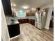 Spacious kitchen featuring stainless steel appliances, dark wood cabinets, and hardwood floors at 6593 N 800 W, Elwood, IN 46036