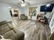 Open living room with hardwood floors, TV, ceiling fan, and comfortable seating at 6593 N 800 W, Elwood, IN 46036