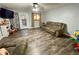 Living room featuring a comfortable sofa, wood-look floors, and natural light at 6593 N 800 W, Elwood, IN 46036