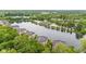 Stunning aerial view of lakeside apartments surrounded by lush greenery and tranquil water at 6760 Spirit Lake Dr # 11, Indianapolis, IN 46220
