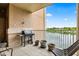 Spacious balcony with a grill, patio seating, and a beautiful lake view at 6760 Spirit Lake Dr # 11, Indianapolis, IN 46220