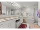 Bright bathroom with double vanity, soaking tub, tiled shower and rug at 6760 Spirit Lake Dr # 11, Indianapolis, IN 46220