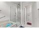 Bathroom with shower with glass doors and tiled walls, soaker tub and white door at 6760 Spirit Lake Dr # 11, Indianapolis, IN 46220