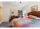 Bedroom with colorful quilt, hardwood furniture, book shelf and window at 6760 Spirit Lake Dr # 11, Indianapolis, IN 46220