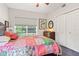 Cozy bedroom with a colorful quilt, natural light, and ample closet space at 6760 Spirit Lake Dr # 11, Indianapolis, IN 46220